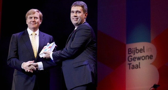 De Koning neemt het eerste exemplaar van de Bijbel in Gewone Taal in ontvangst.