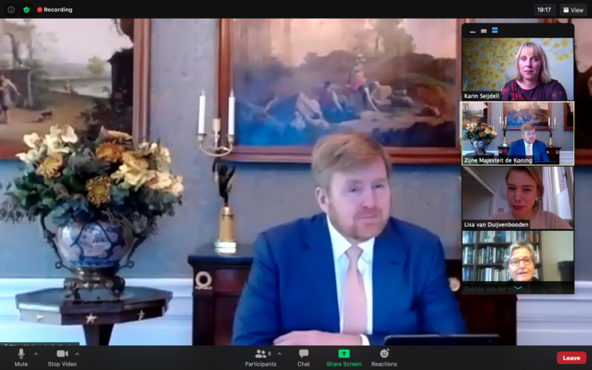 Koning spreekt online met drie personen.